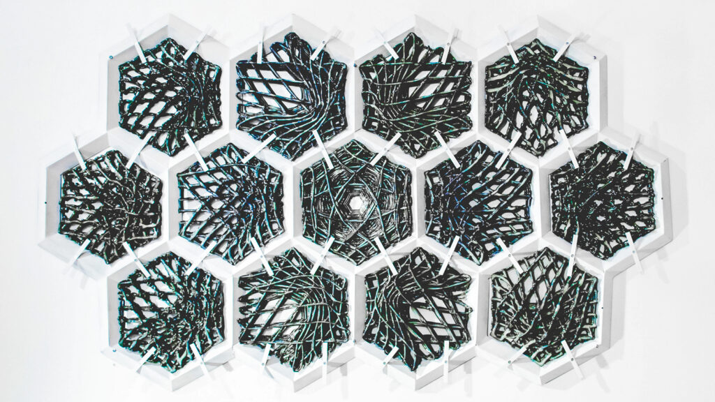 A series of grey hexagons created by a 3D printer