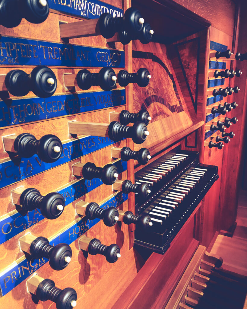 Detail view of the stops, keyboards, and pedals of the organ at Anabel Taylor Chapel