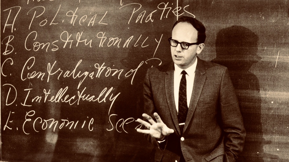 Walter LaFeber lectures in front of a blackboard