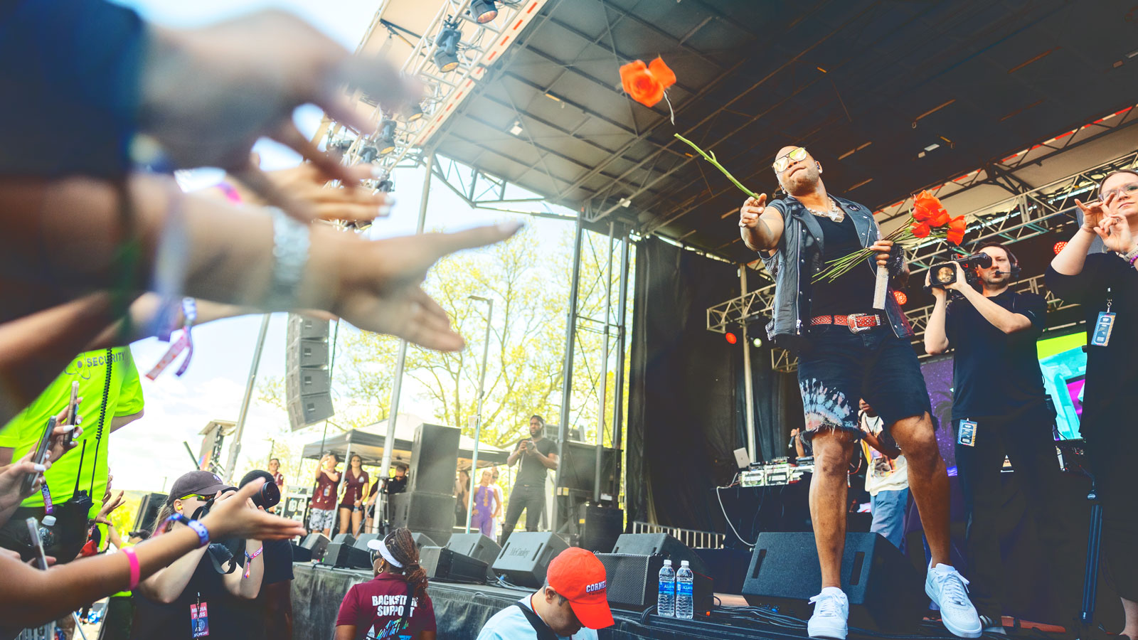 Flo Rida throws roses to audience members during Slope Day 2024
