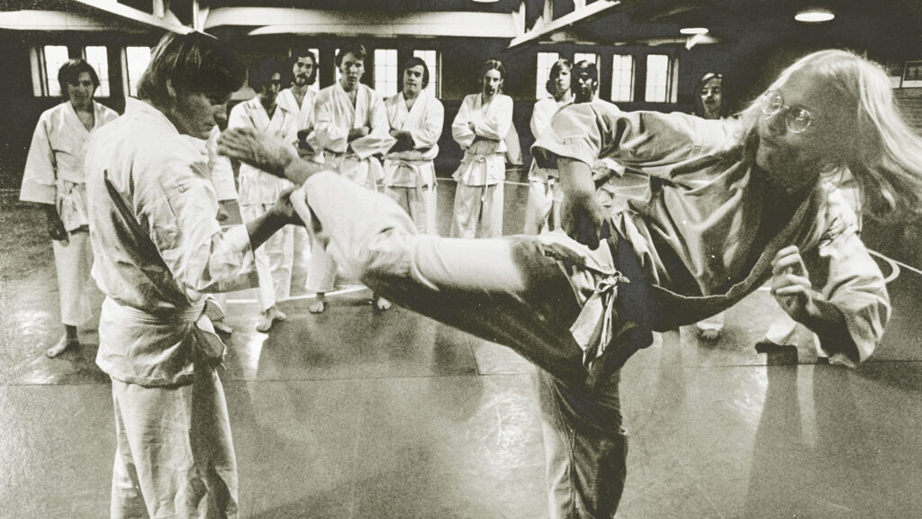 A karate class with a student mid kick in 1972