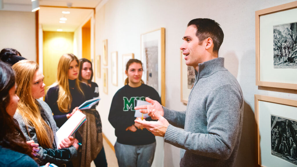 Professor Michael Fontaine talks to a group of students during a wine classics course visit to the Johnson Museum.