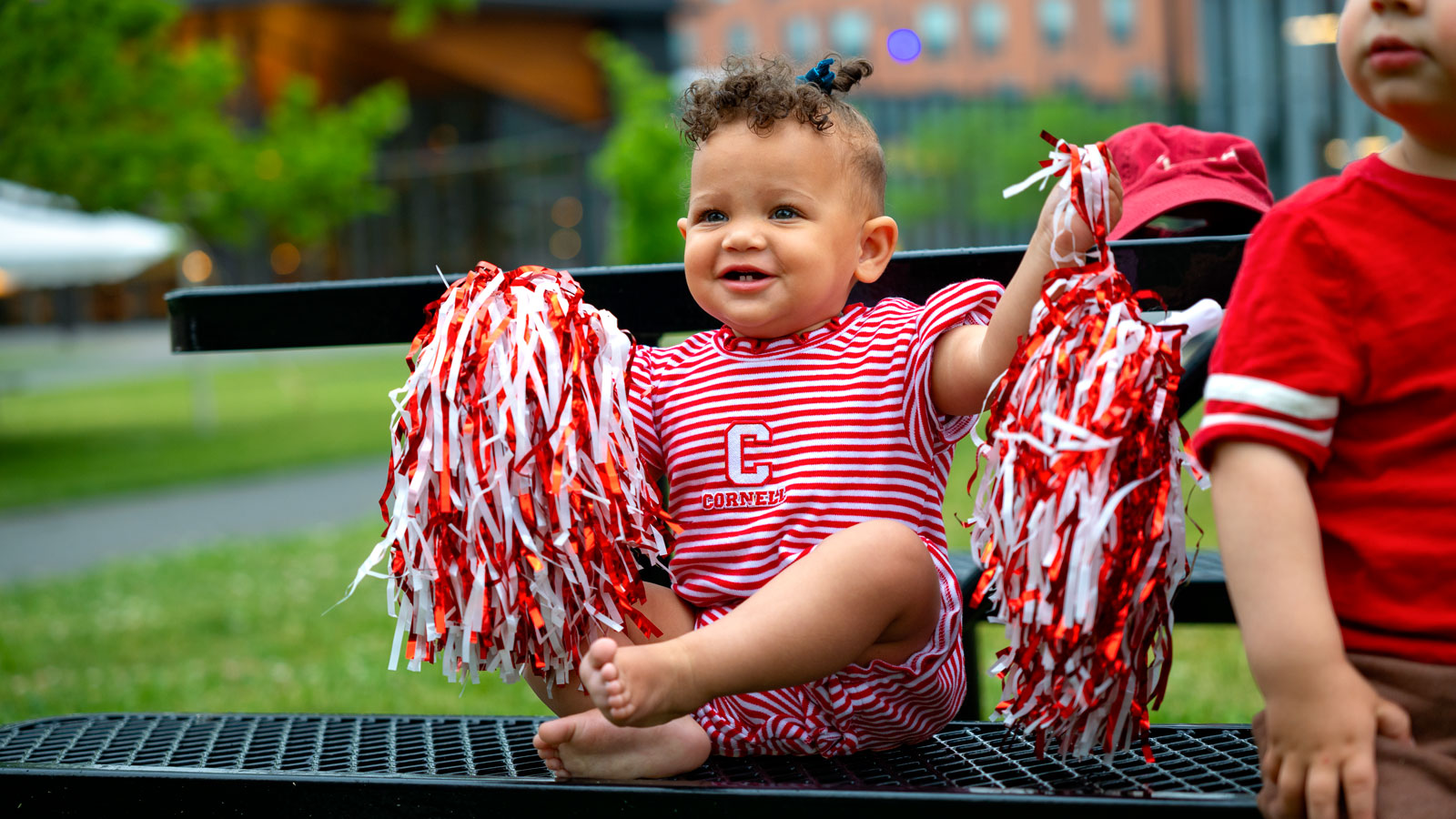 A baby shows off Cornell swag at Reunion 2024
