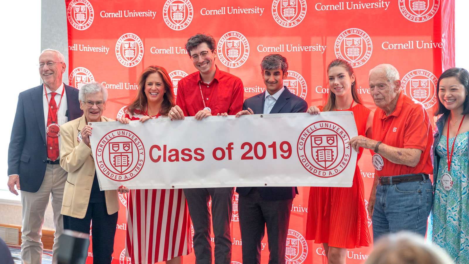 Marty Coler Risch, Class of 1949, passes the traditional banner to the youngest reunion class of 2019 during the "Spirit of '31" event during Reunion 2024
