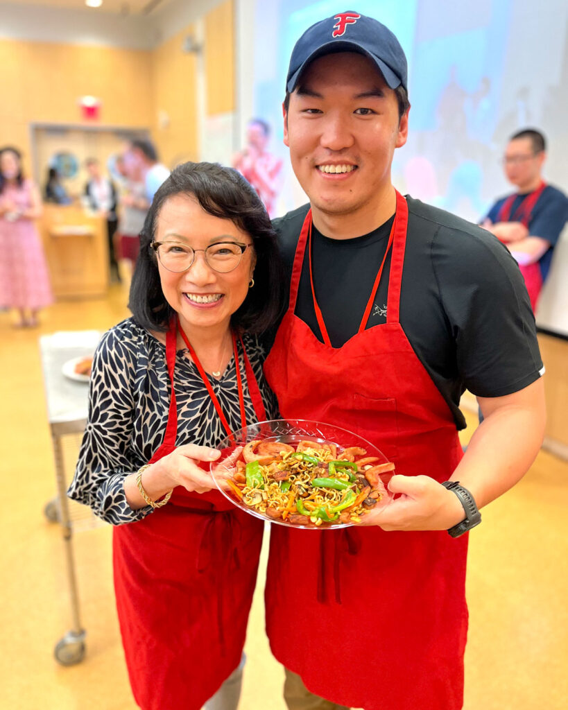 Two participants in the Ivy Iron Chef Challenge held at Reunion, hosted by the Cornell Asian Alumni Association