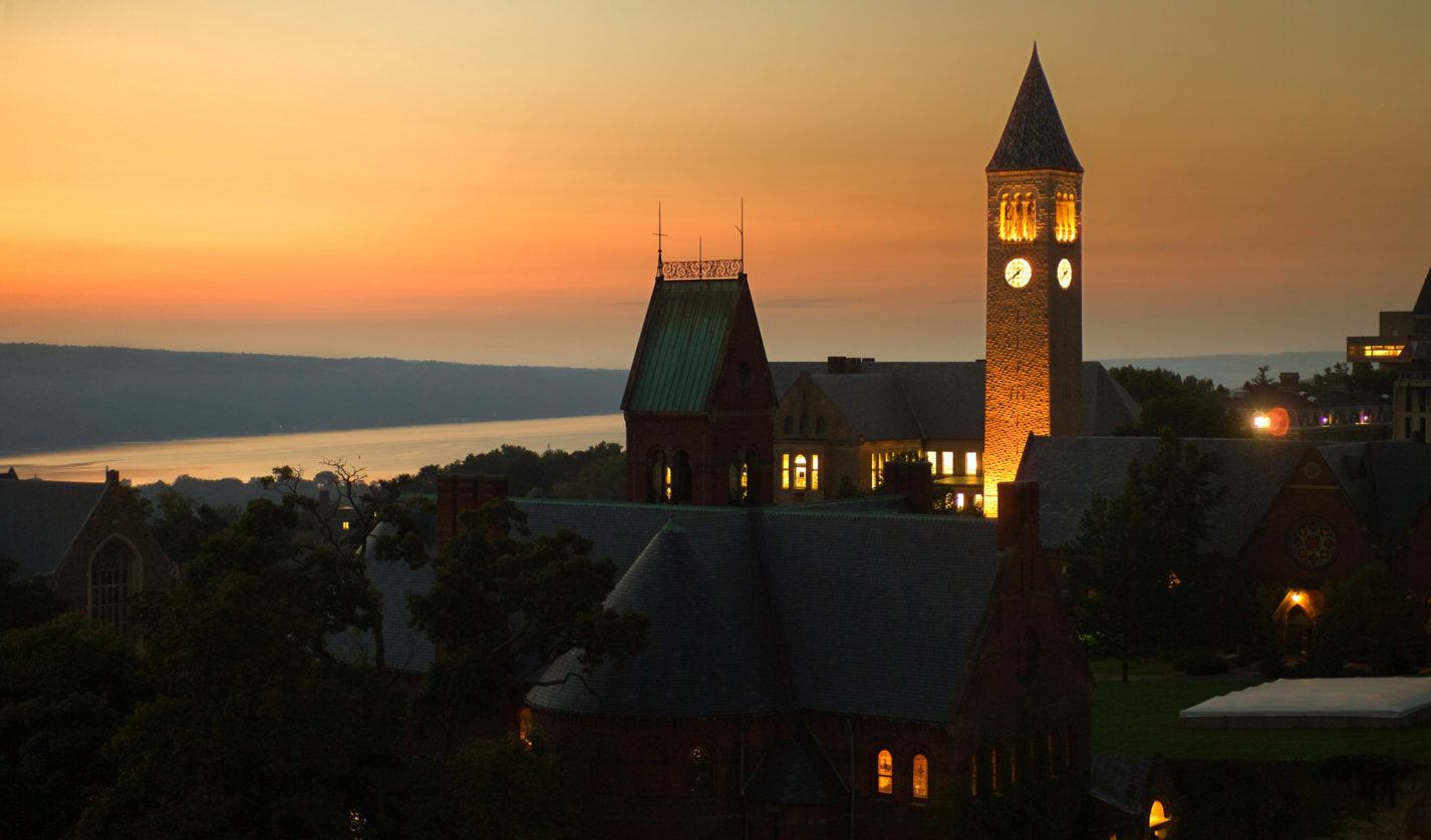 Central campus at dusk, with views of McGraw tower and Cayuga Lake.