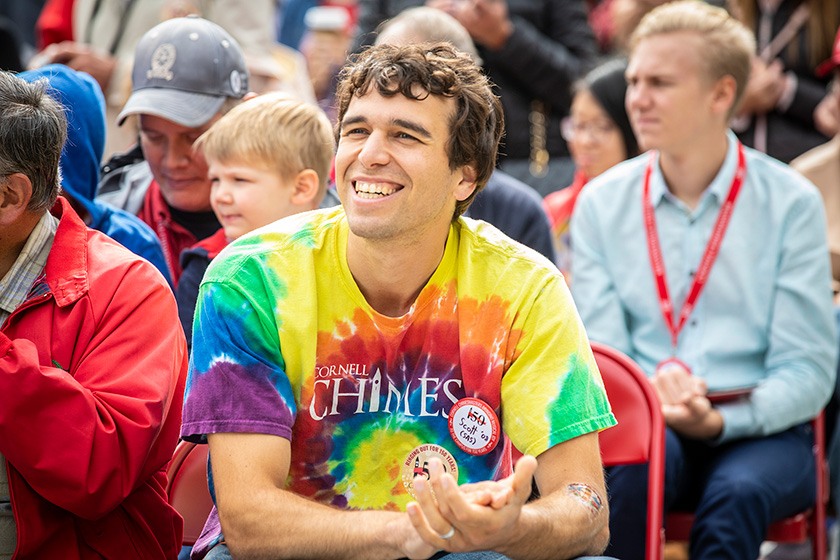 A chimesmaster alumnus in a tie-dyed Cornell Chimes t-shirt