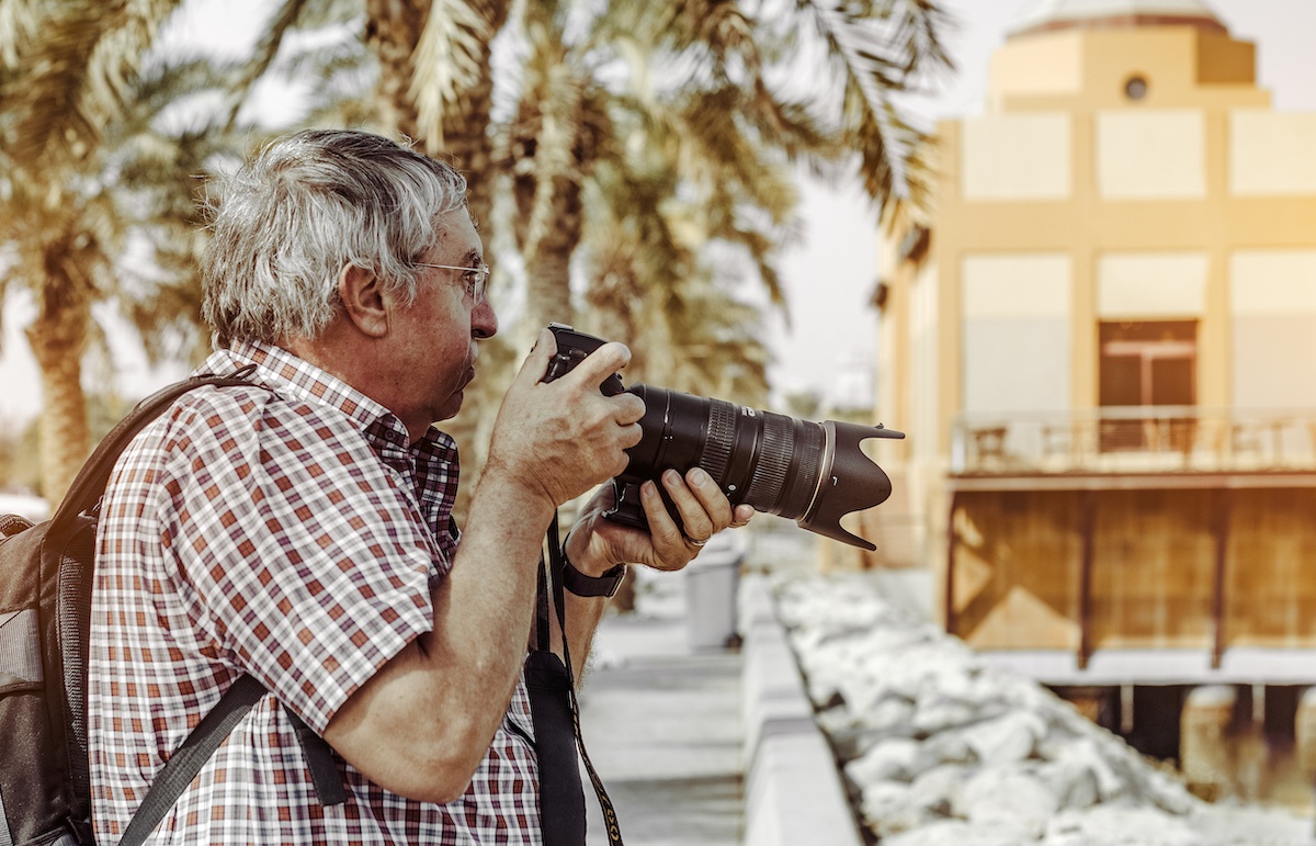 older man taking photos