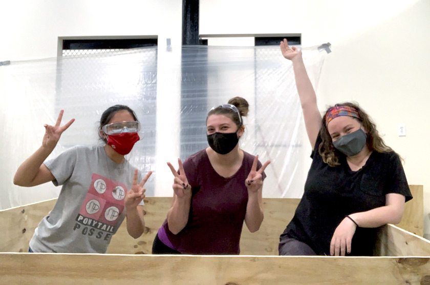 INERTIA Build Team members (L to R) Sabriyah Taher, Sophia Peris, and Olivia Goosay ’23 are building the wall of printers in the South Hill Business Campus Lab of Ithaca College.