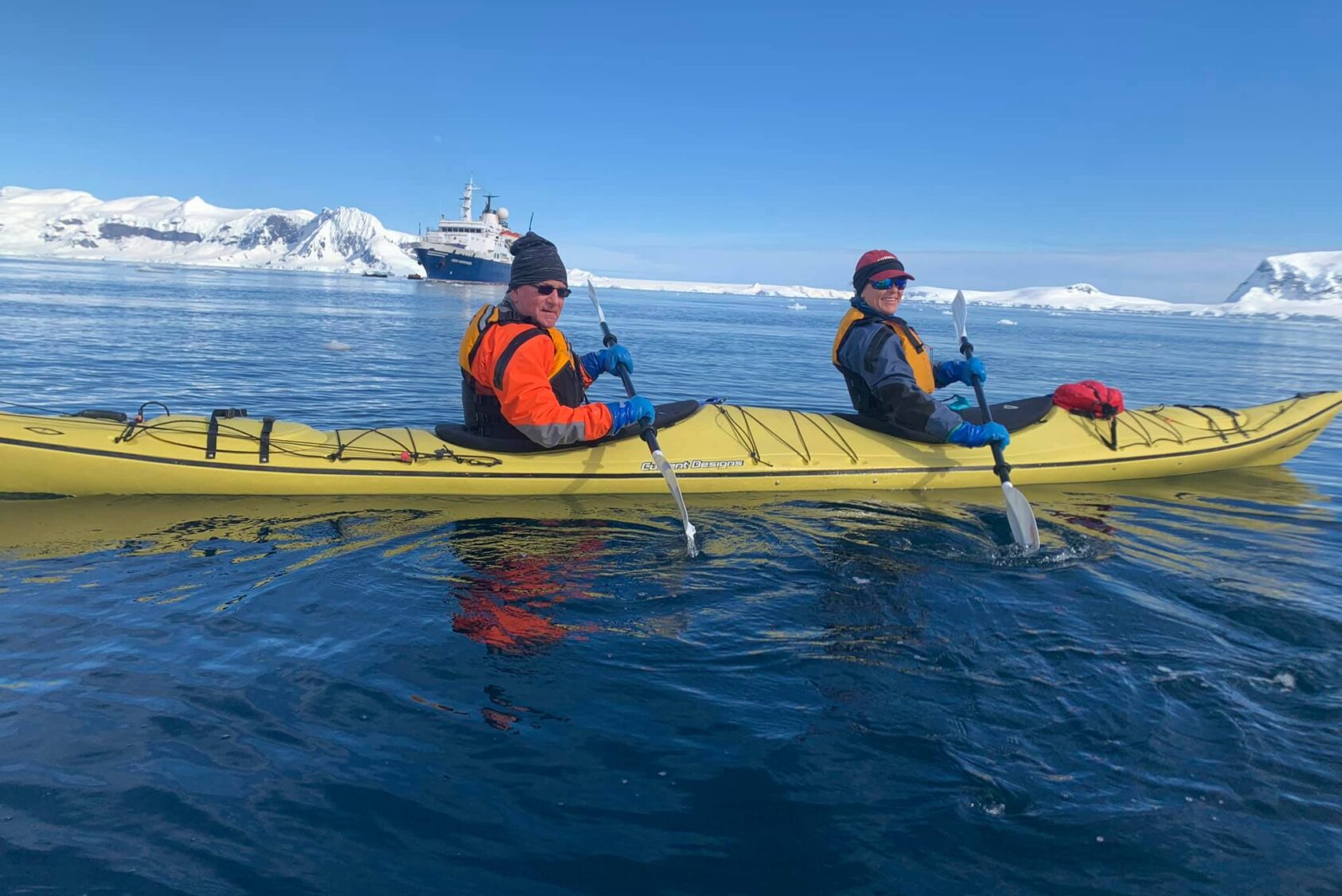 alumni on a kayak in Antarctica