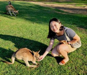 Kai Lin feeds a baby kangaroo on a recent trip to Australia