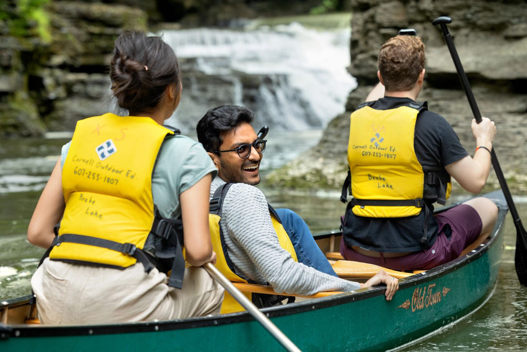 A trio in a canoe in the waters of Upstate New York