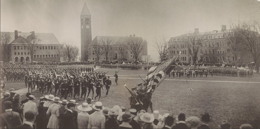 In the early days, all male students at Cornell were required to complete two years of mandatory military drill and military sciences classes. Here, the ‘Corps of Cadets’ march around the Arts Quad. Source: https://armyrotc.cornell.edu/the-legacy/.