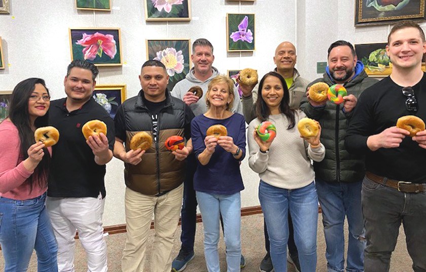 Linda (Edelman) Bradley ’84 (center in purple shirt) and Poppyseed Project volunteers rescue end-day bagels and deliver them to local food pantries.